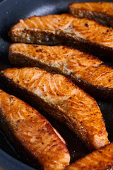 Salmon fillets in the frying pan