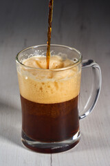 Pouring brown ale in a mug