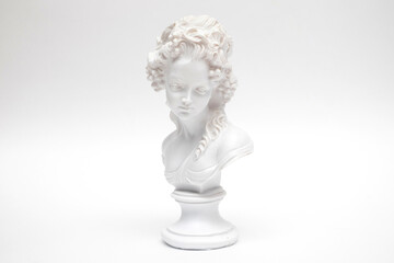 Decorative plaster statuette of a woman head on white background
