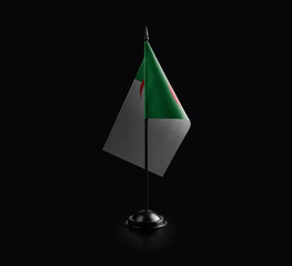 Small national flag of the Algeria on a black background