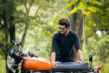 Young Indian guy with new motorbike.