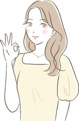 OKポーズをする明るい雰囲気の女性