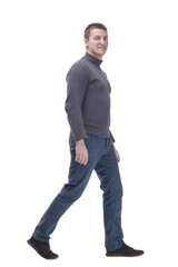 young man in casual clothing striding forward.