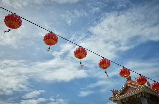 Chinese red lanterns on blue sky and temple