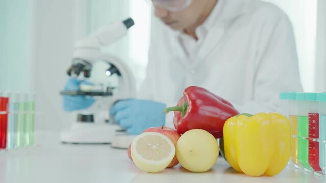 Scientist check chemical food residues in laboratory. Control experts inspect quality of fruits, vegetables. lab, hazards, ROHs, find prohibited substances, contaminate, Microscope, Microbiologist