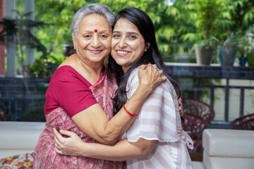 Portrait of happy young indian daughter mother hug each other at home, Love and bonding, Asian...