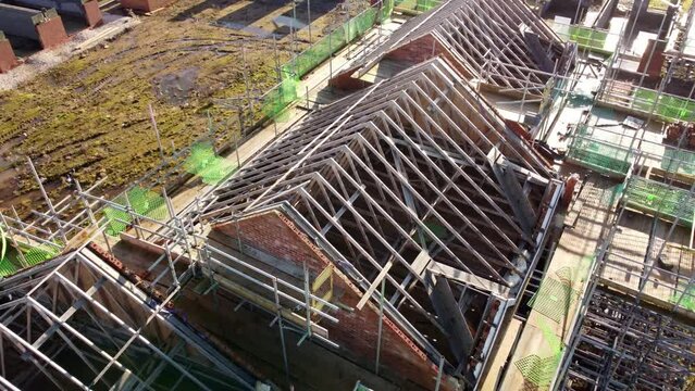 Unfinished timber rooftop scaffolding framework on townhouse property development site, Aerial view