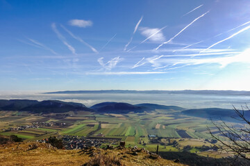 wonderful view to dense fog at the horizon with blue sky and sunshine