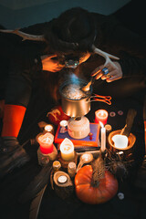 Close up woman illuminating brew in pot with headlamp portrait picture. Funny blackout. Closeup top...