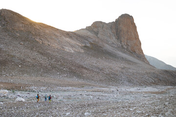A group of people travel through the mountains. Active rest in mountain hiking. Adventure in the mountains.