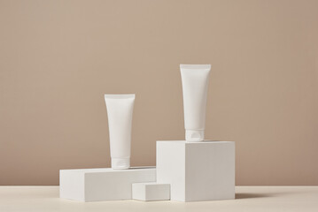Unbranded blank cosmetics packages on a pedestal. Skincare female products