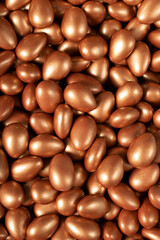 Chocolate dragee in the form of a pile. Brown dragee chocolate with chocolate filling. Top view. close up