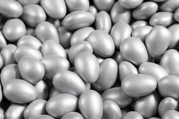 Chocolate dragee in the form of a pile. Gray dragee chocolate covered with sugar on the outside and filled with chocolate on the inside. close up