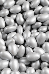 Chocolate dragee in the form of a pile. Gray dragee chocolate covered with sugar on the outside and filled with chocolate on the inside. close up