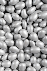 Chocolate dragee in the form of a pile. Gray dragee chocolate covered with sugar on the outside and filled with chocolate on the inside. Top view. close up