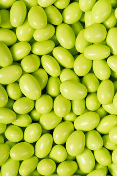 Chocolate dragee in the form of a pile. Green dragee chocolate covered with sugar on the outside and filled with chocolate inside. Top view. close up