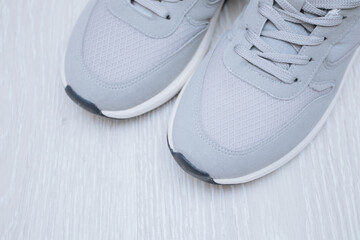 Pair of grey shoes on floor. Top view