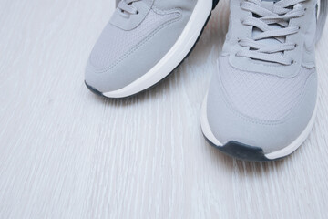 Pair of grey shoes on floor