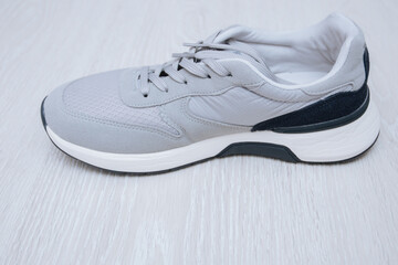 new grey sneakers on floor