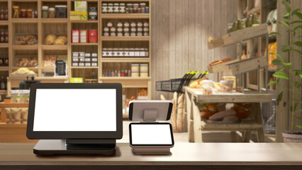 Cash register with blank computer monitor screen, white touchscreen tablet on wooden counter in cozy, luxury organic, eco-friendly bakery grocery store with shelf, product display in background 3D - obrazy, fototapety, plakaty