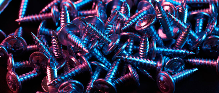 Set of bolts nuts nails metal fasteners. Consumable hardware tools. assortment steel screws collection close up background
