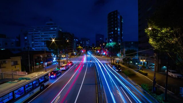 A night timelapse of the traffic jam at the city crossing in Tokyo wide shot tilt