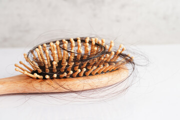 Hair loss fall with comb brush isolated on white background.