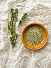 Dried and chopped rosemary on baking paper