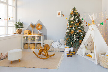 room interior with Christmas tree decorated with golden balls toys on blurred, sparkling and fabulous fairy tale background with beautiful bokeh