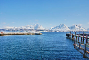 winter landscape with snow covered mountains o a fjord