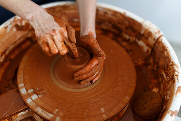 Cropped Image of Unrecognizable Female Ceramics Maker working with Pottery Wheel in Cozy Workshop Makes a Future Vase or Mug, Creative People Handcraft Pottery Class