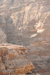 sitting on the edge of the canyon, Petra trail, jordan