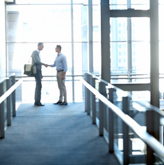 Business men, handshake or greeting in hotel lobby, modern office or airport lounge in CRM team meeting. Corporate workers, employees or shaking hands in partnership deal, collaboration or agreement