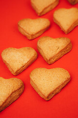 Shortbread cookies in the form of hearts on a red background. Background, Valentine's Day. Top view, selective focus