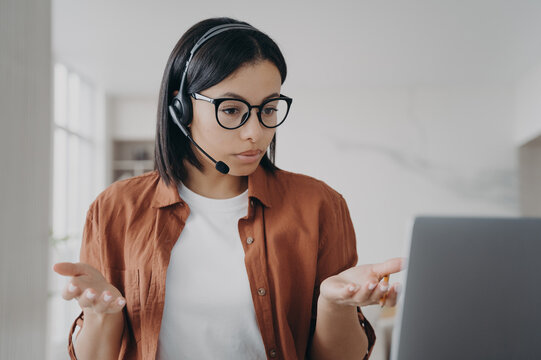 Young European Woman Has Online Conference Or Interview. Businesswoman In Headset Is Talking.