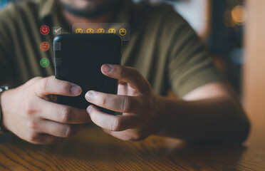 Concept of customer experiences. A satisfied customer uses a smartphone to rate online satisfaction surveys with five stars. Positive Comments Regarding Mobile Phone