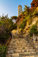 Le Phare Lighthouse at southern rocky shore of Cap Ferrat cape at French Riviera of Mediterranean Sea in France
