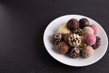 A photo of a lot of different candies lying in a plate