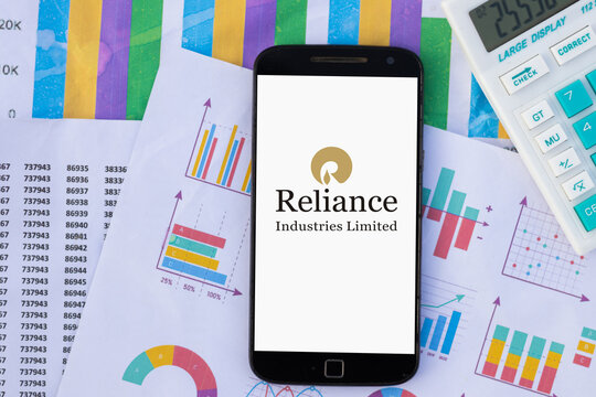 Reliance industries limited RIL logo on smartphone screen with chart and graph