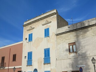 Fototapeta na wymiar Marsala Street View with Building with Blue Wooden Shutters in Sicily, Italy