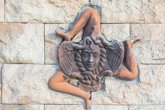 Ceramic Sicilian triskelion on the wall. Trinacria traditional symbol of Sicily. 