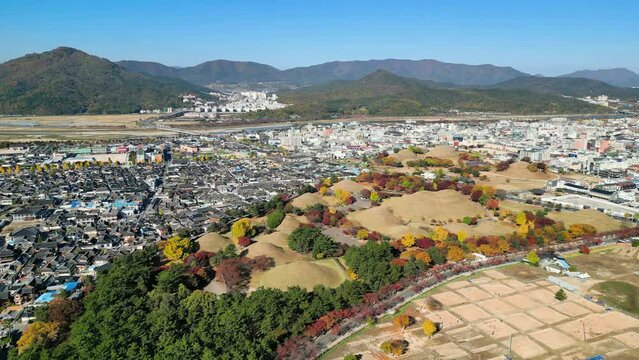 Gyeongju: Aerial view of city in South Korea, Daereungwon Tomb Complex, trees in autumn colors - landscape panorama of East Asia from above