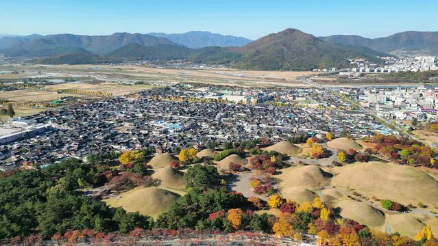 Gyeongju: Aerial view of city in South Korea, Daereungwon Tomb Complex, trees in autumn colors - landscape panorama of East Asia from above