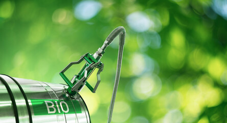 Biofuel filling nozzle with storage tank on a green background