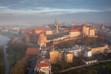 Naklejka na ściany i meble Foggy sunrise at Wawel Castle in Krakow. Poland