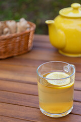 Tea with lemon and ginger on a rustic wooden table. Strengthen your immune system. Alternative medicine. Wellness and health.