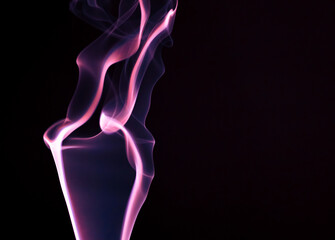 Colored smoke on a black background.Abstract streaks from smoke.