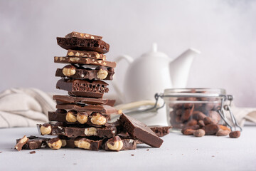 Pieces of chocolate bars with nuts for tasty break or as ingredient for cooking