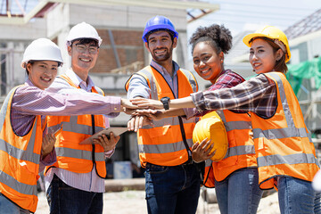 Young engineer team join hands with new startups in creative office - Cheerful people give strong motivation - Emphasis on female hand wearing red head - Co-working and Teamwork Concept