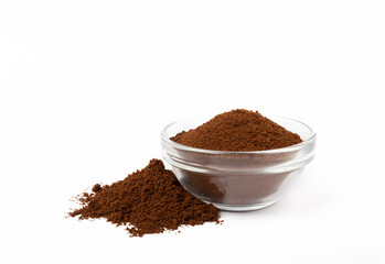 Ground coffee in a bowl isolated on a white background.